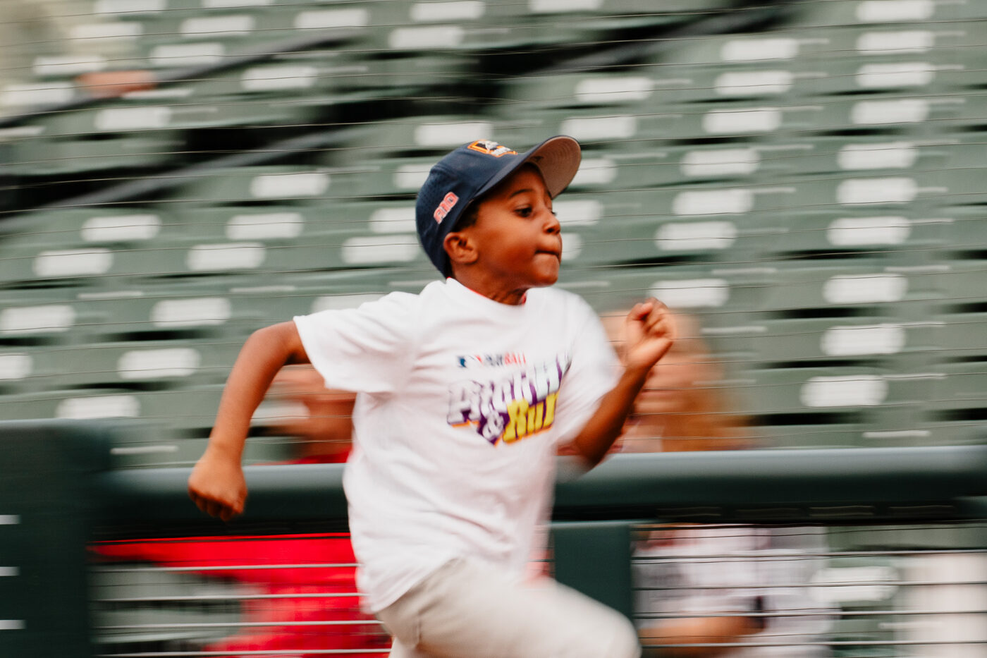 Youth athlete sprinting across the base path