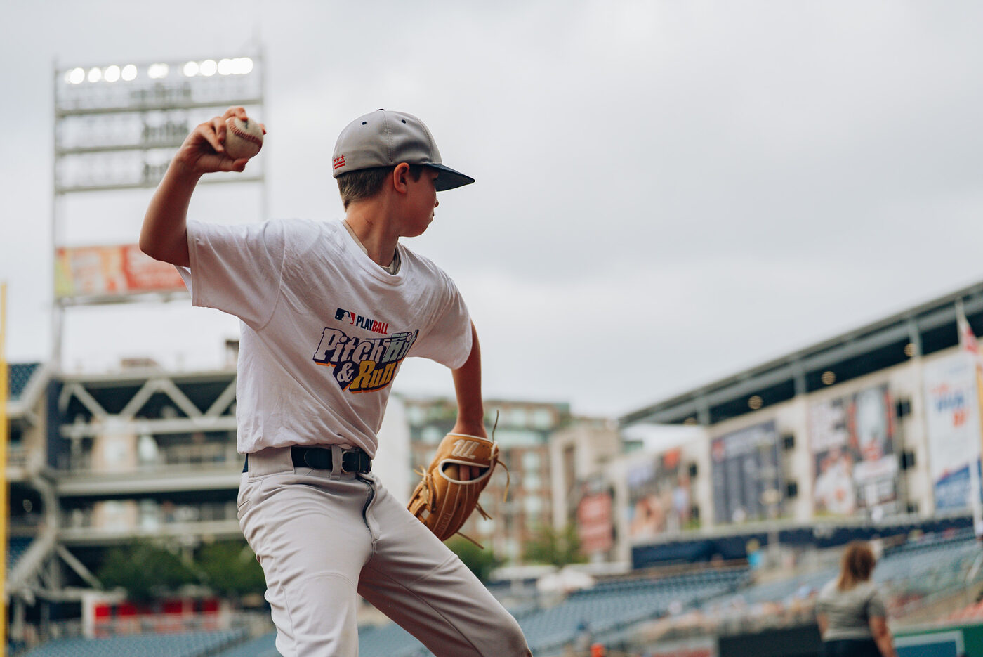 Youth pitcher throwing a baseball toward the target