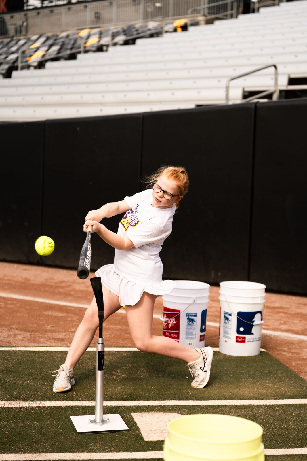 Young batter preparing to hit baseball off a tee